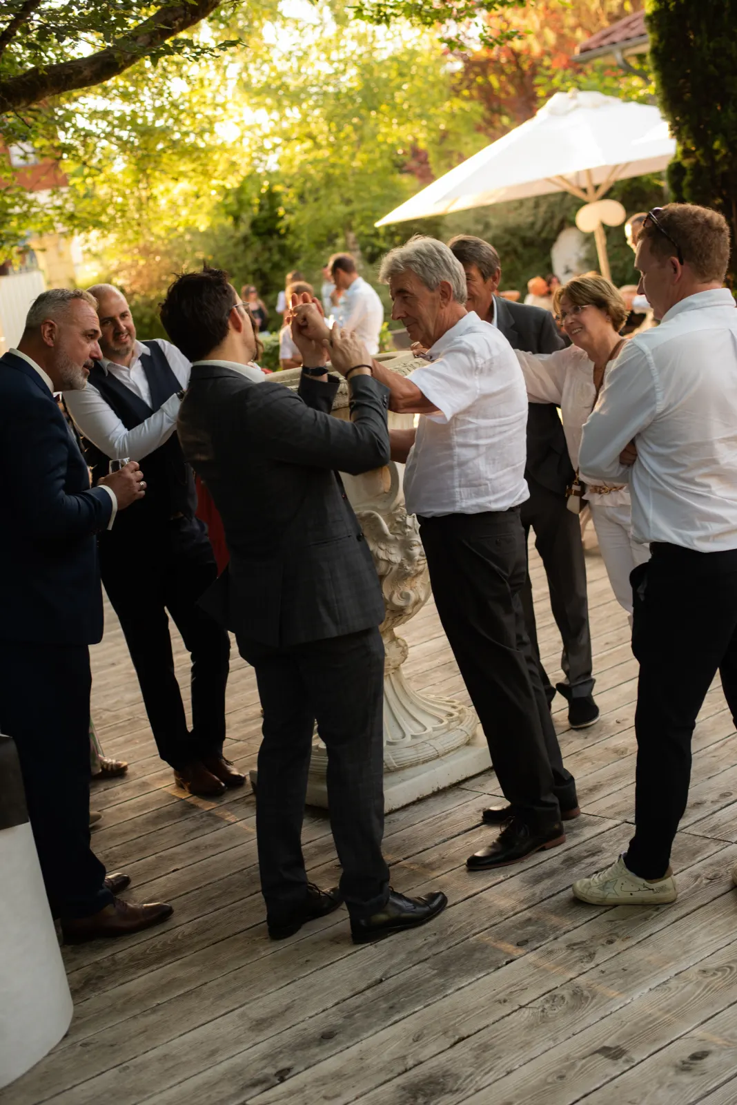 Vin d'honneur en extérieur dans un domaine, invités réunis en petits groupes